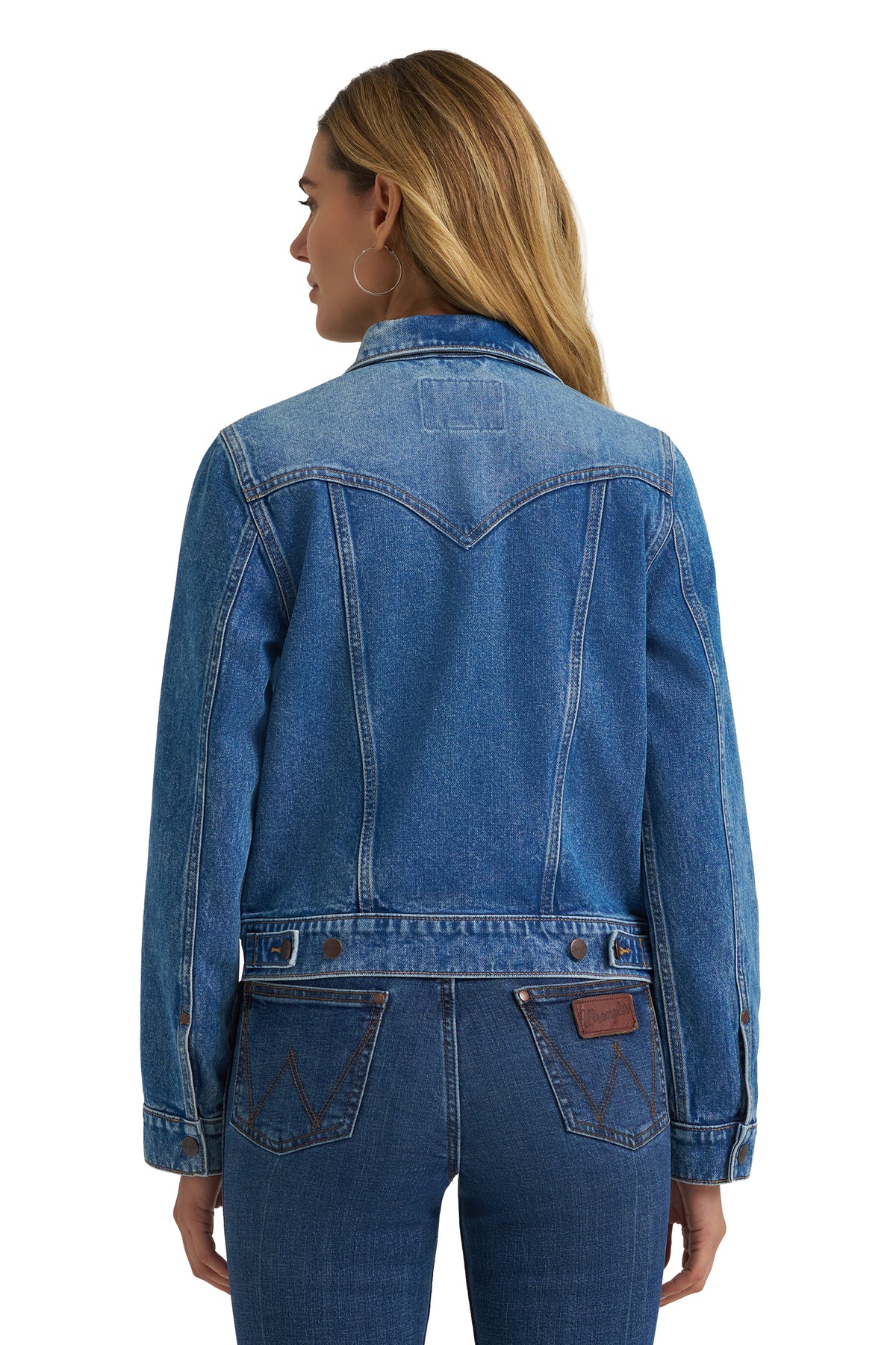 Person wearing a blue denim jacket on a white background