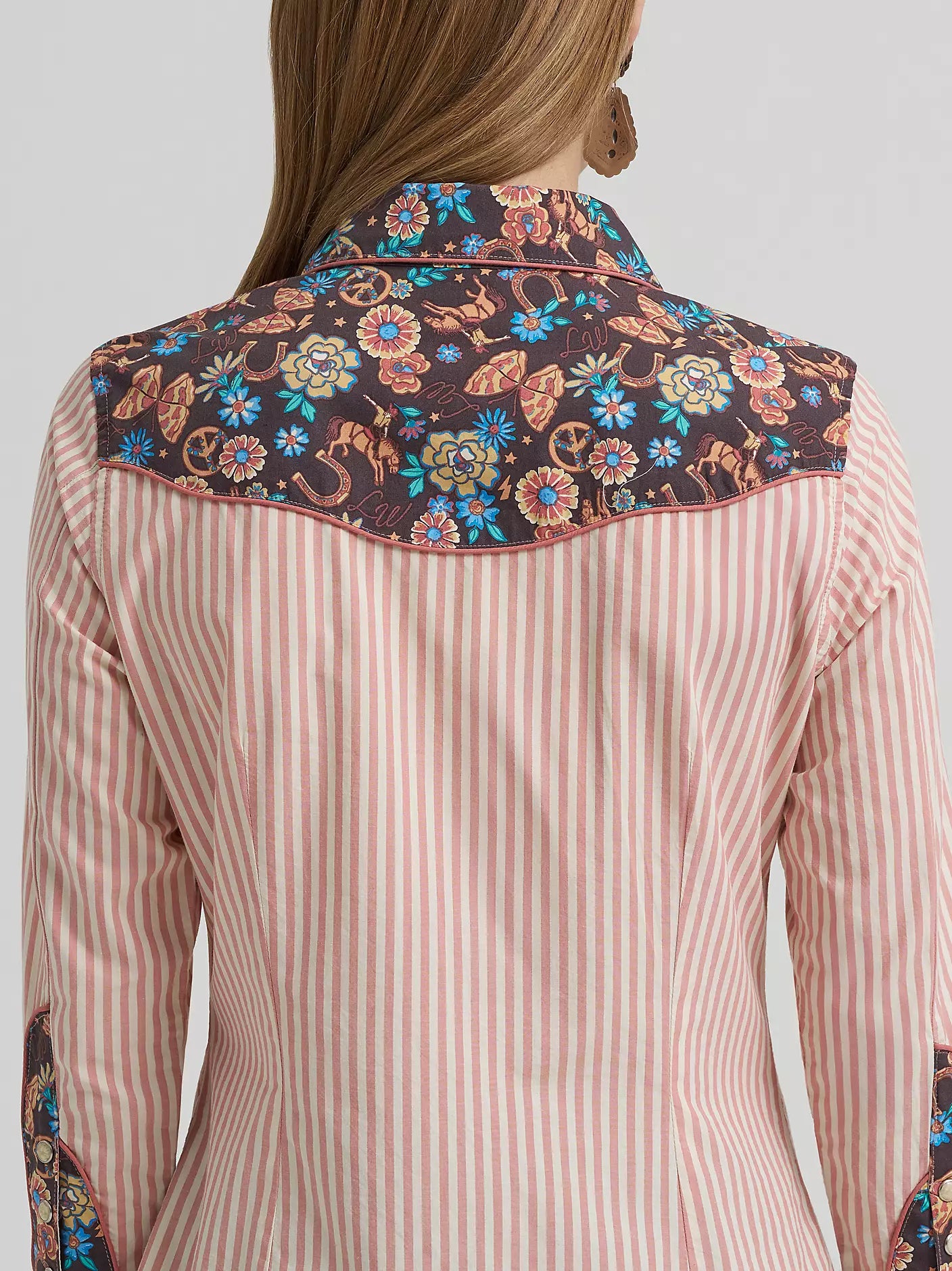 Striped shirt with floral embroidery on a plain background