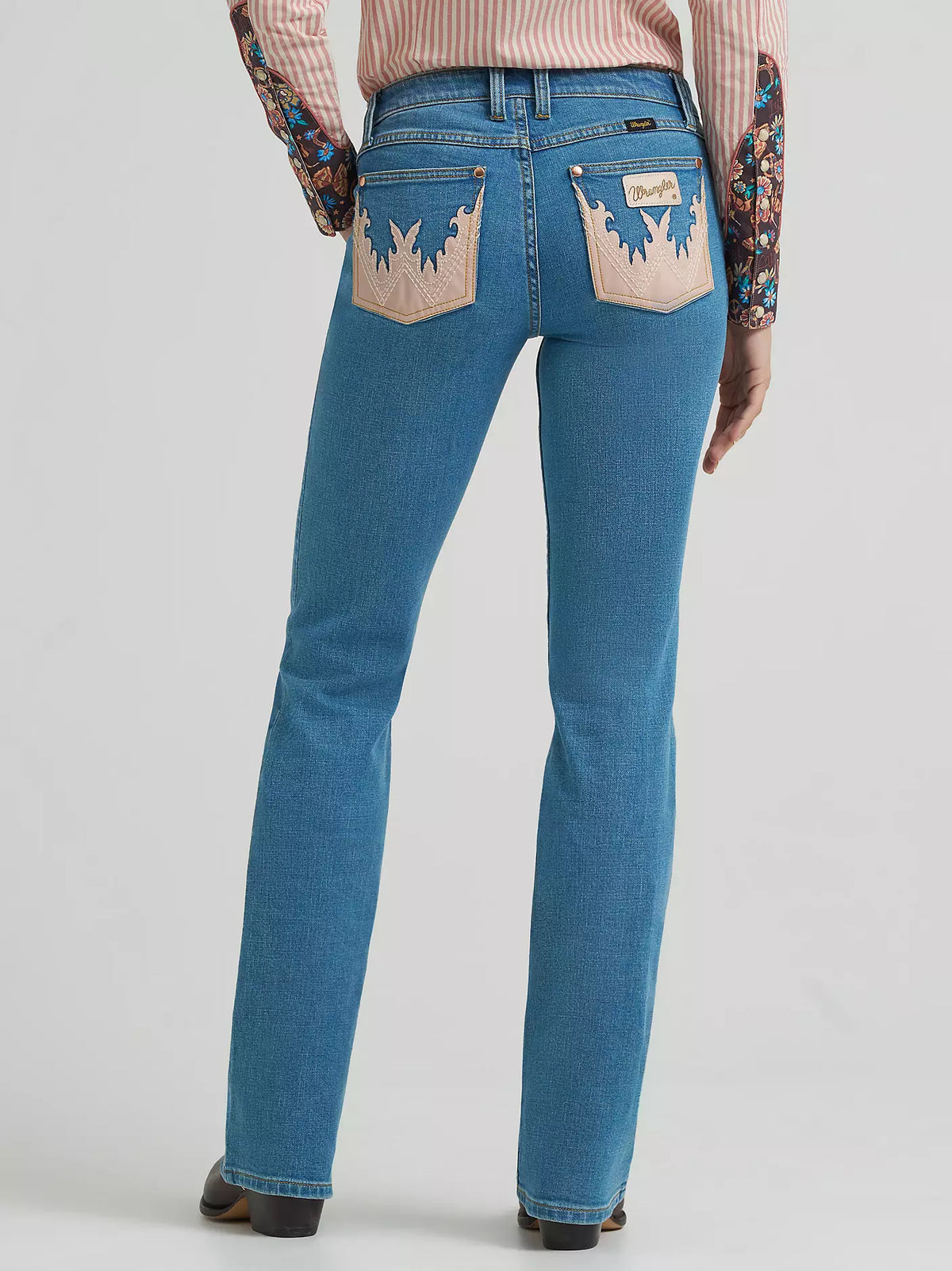 Blue jeans with decorative back pockets on a white background