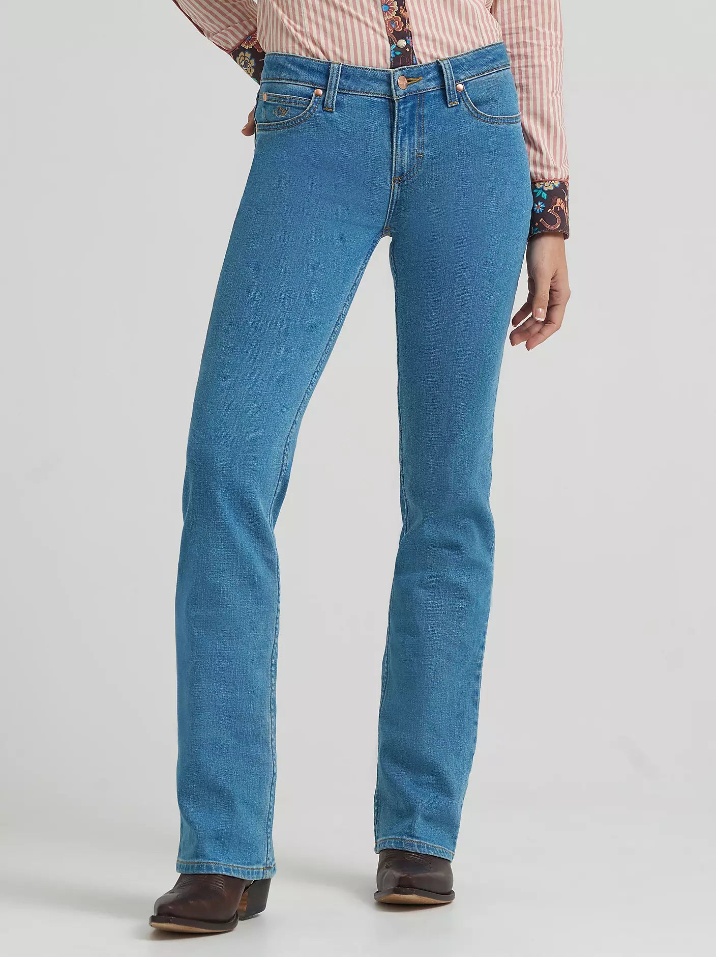 Blue jeans worn by a person on a light gray background