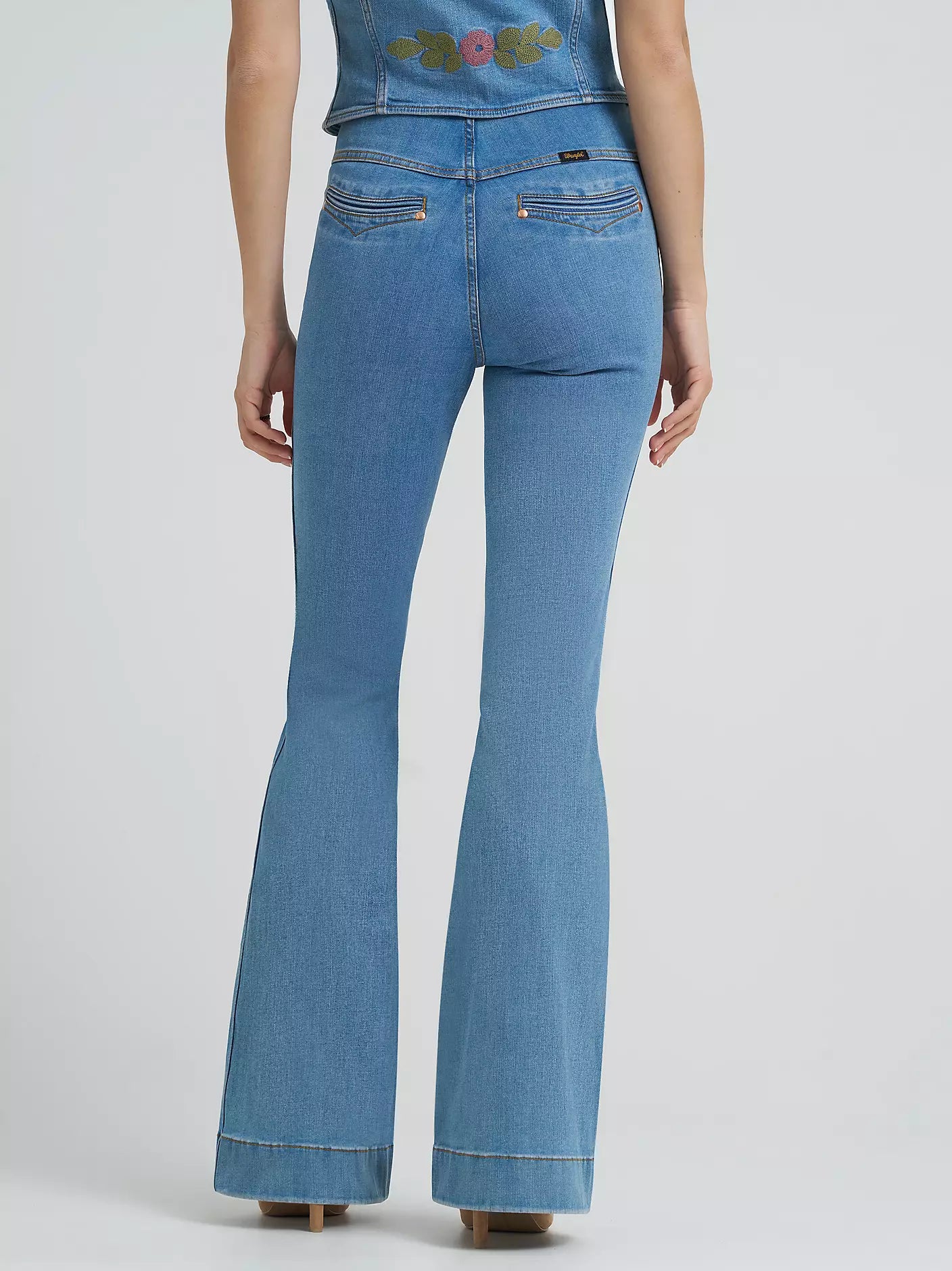 Blue jeans worn by a person on a light gray background