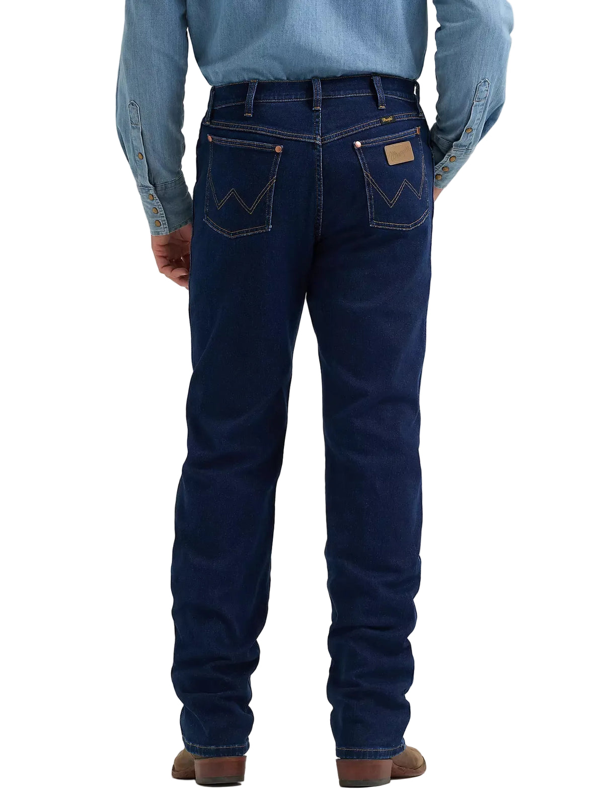 Rear view of a person wearing dark blue denim jeans with a light blue button-up shirt and brown shoes, shown against a light gray studio background.