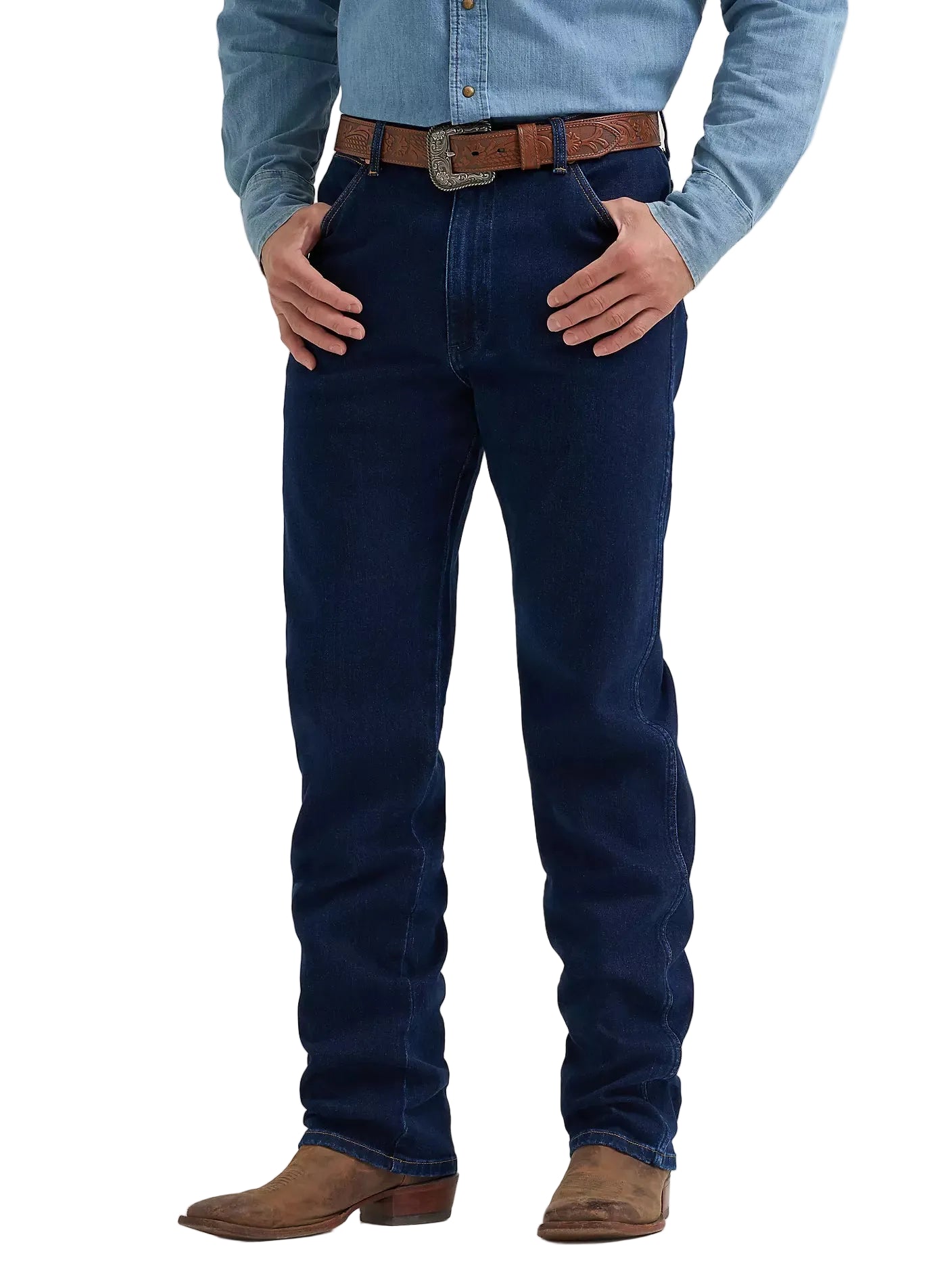 A person wearing dark blue denim jeans with a brown leather belt, a light blue denim shirt, and brown suede boots, shown from the waist down on a light gray studio background.