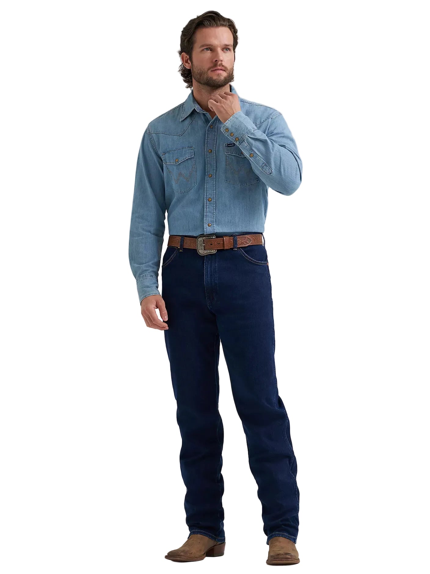 A man modeling a light blue long-sleeve western-style denim shirt with dark blue jeans, a brown leather belt, and brown boots, standing against a light gray studio background.