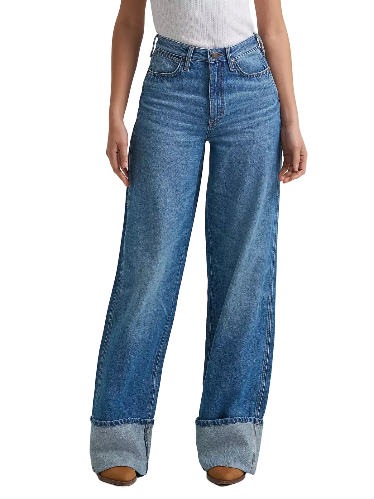 Person wearing blue wide-leg jeans on a light gray background