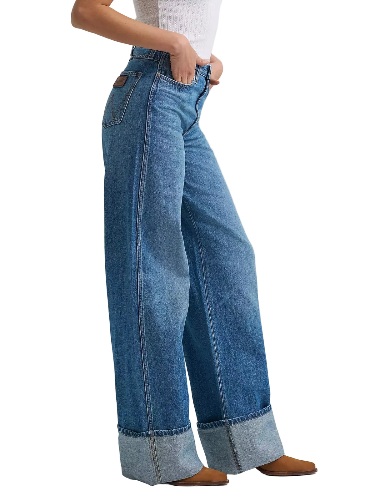 Person wearing blue wide-leg jeans on a light gray background