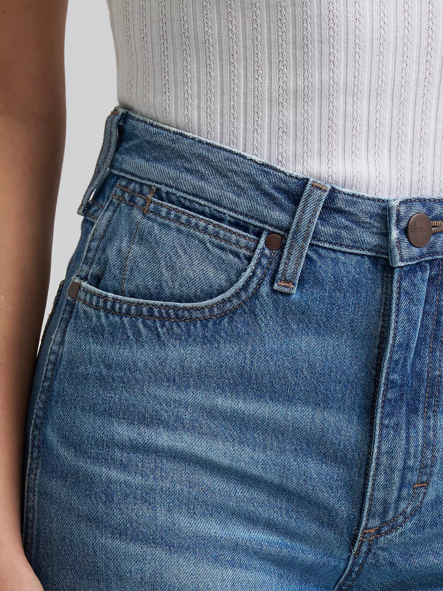 Close-up of blue jeans with a plain background
