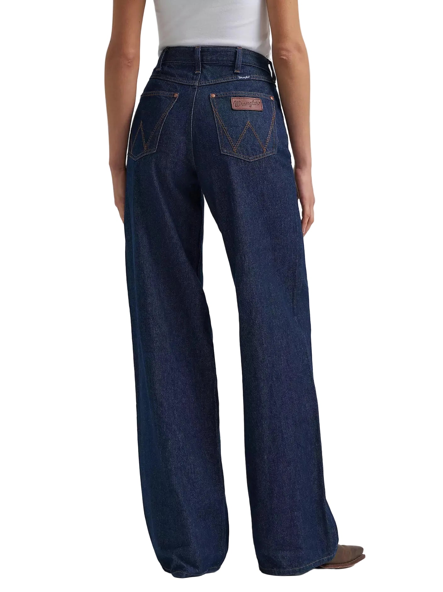 Dark blue jeans worn by a person on a light gray background