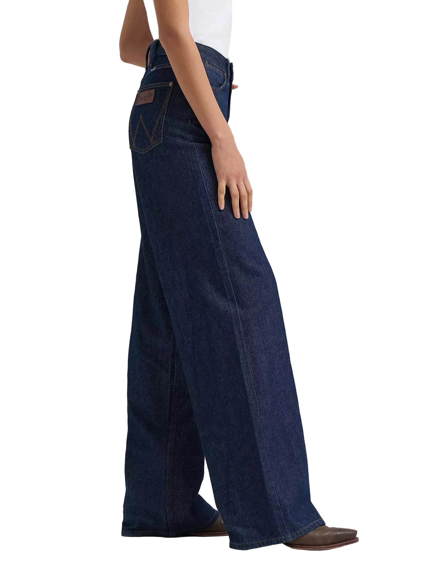 Person wearing dark blue wide-leg jeans on a light gray background