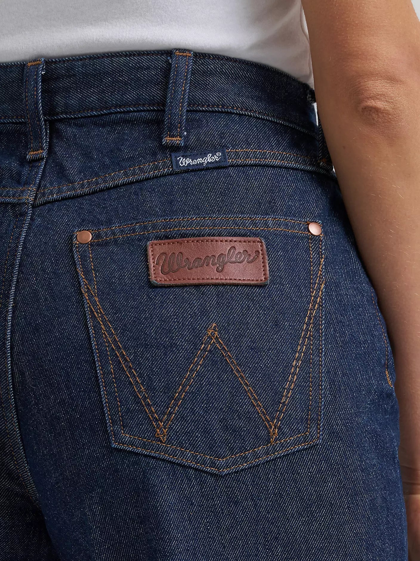 Close-up of Wrangler jeans with brand logo on pocket