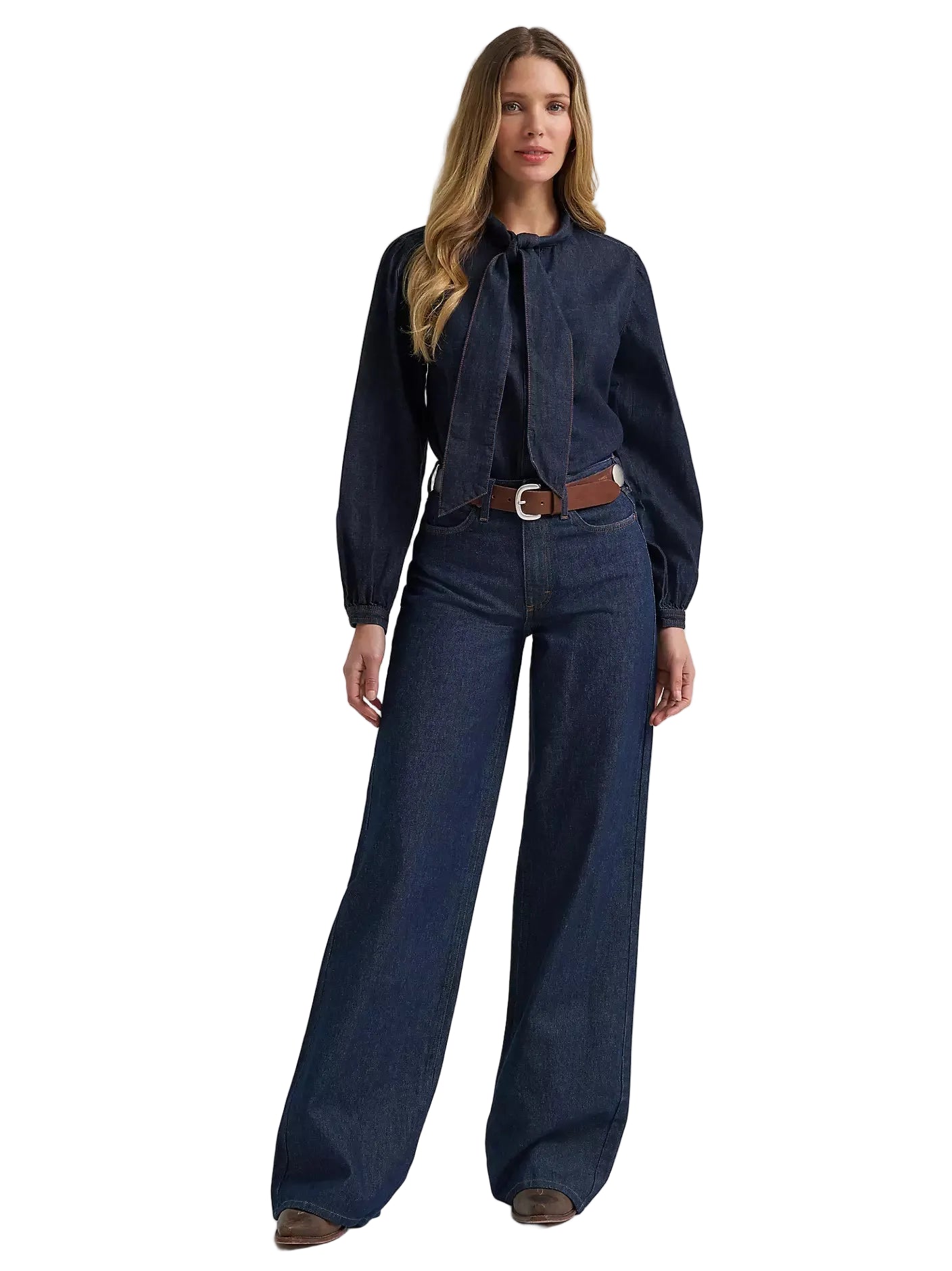 Woman wearing a dark denim shirt and wide-leg jeans on a white background