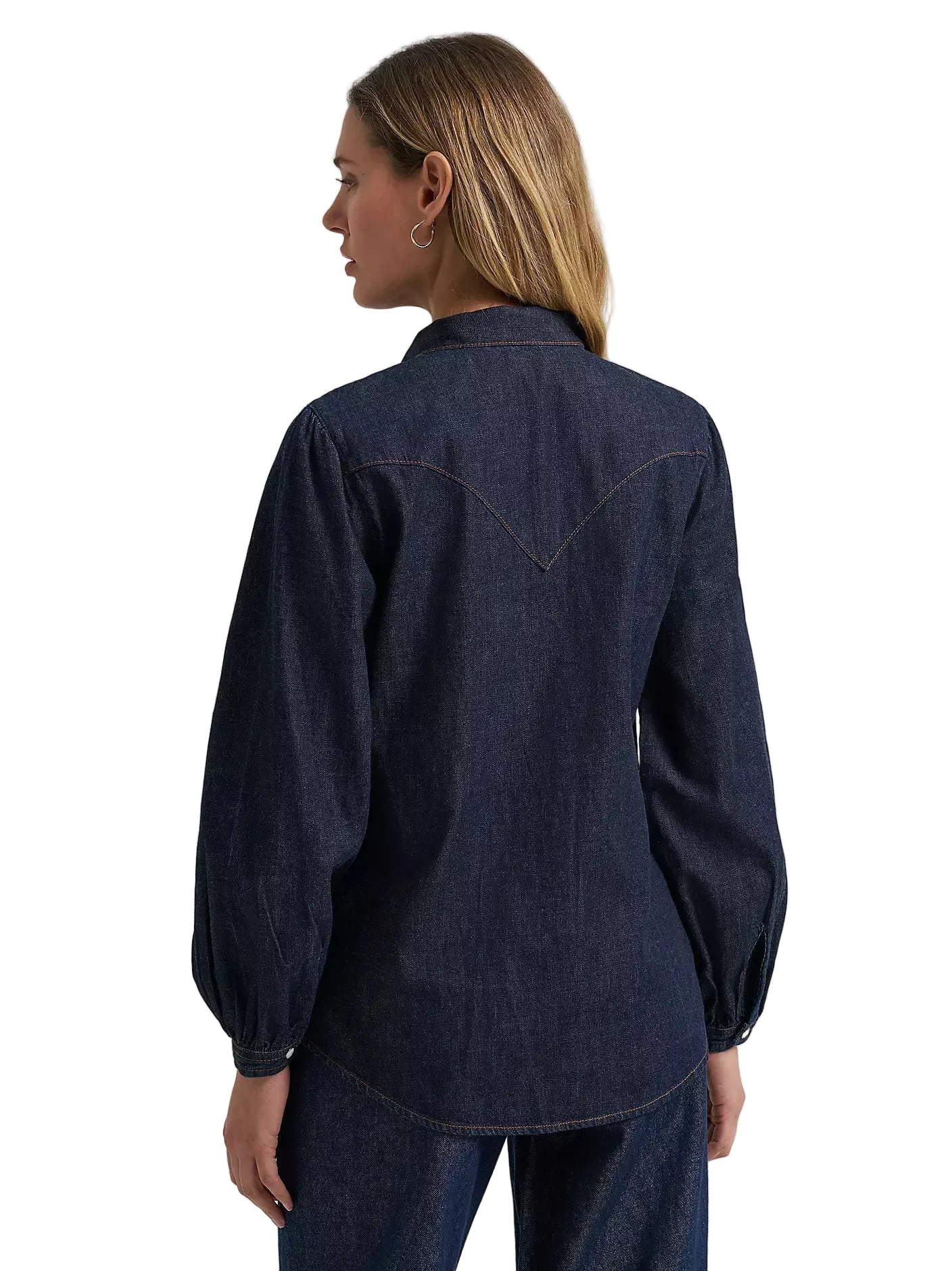 Person wearing a dark denim shirt with a plain background