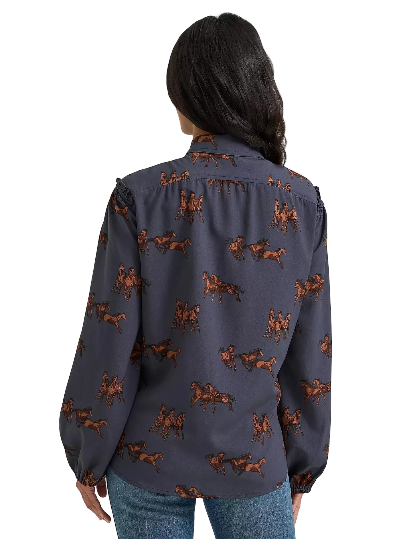 Woman wearing a navy blue shirt with horse pattern on a gray background
