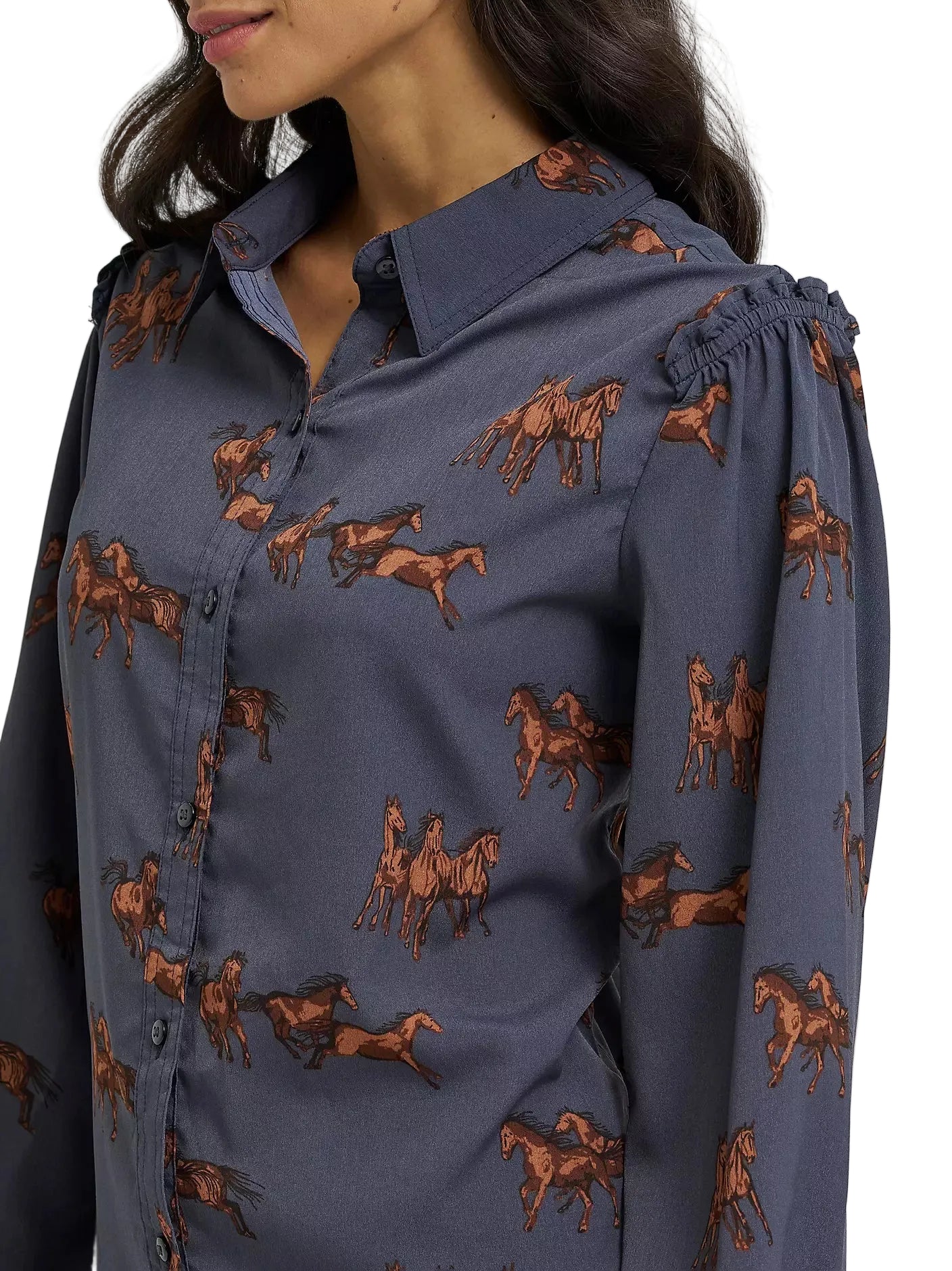 Blue shirt with horse pattern worn by a person on a white background