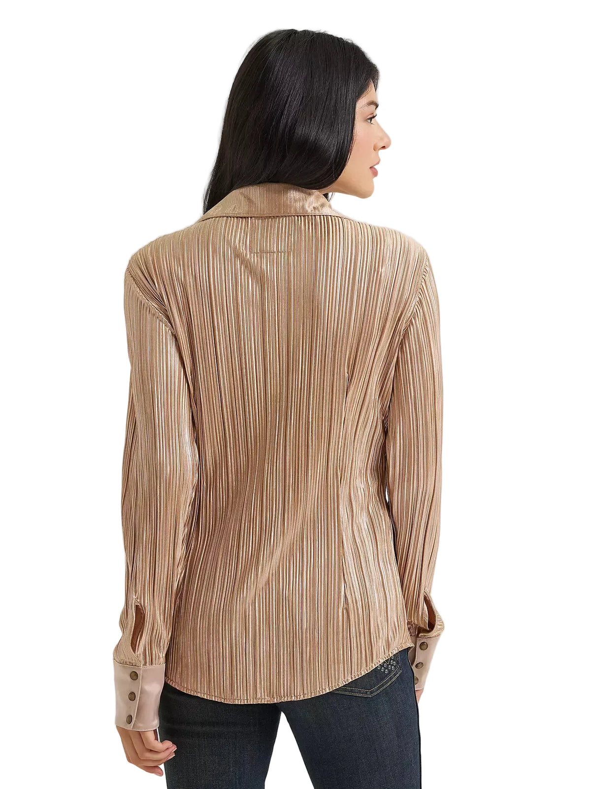 A woman shown from the back wearing a beige pleated long-sleeve blouse with dark blue jeans, photographed against a light gray studio background.