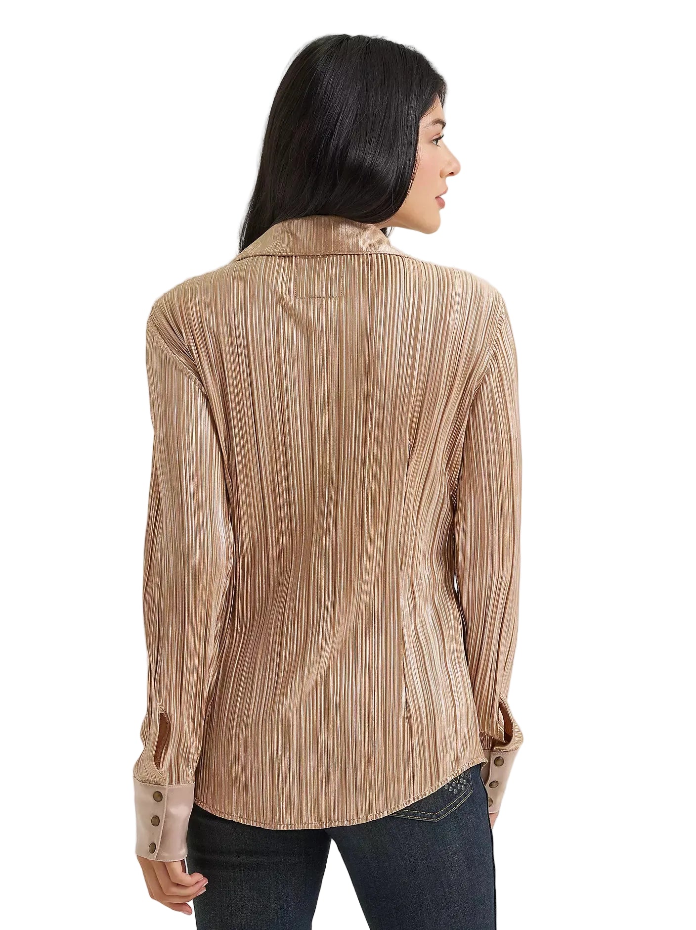 A woman shown from the back wearing a beige pleated long-sleeve blouse with dark blue jeans, photographed against a light gray studio background.