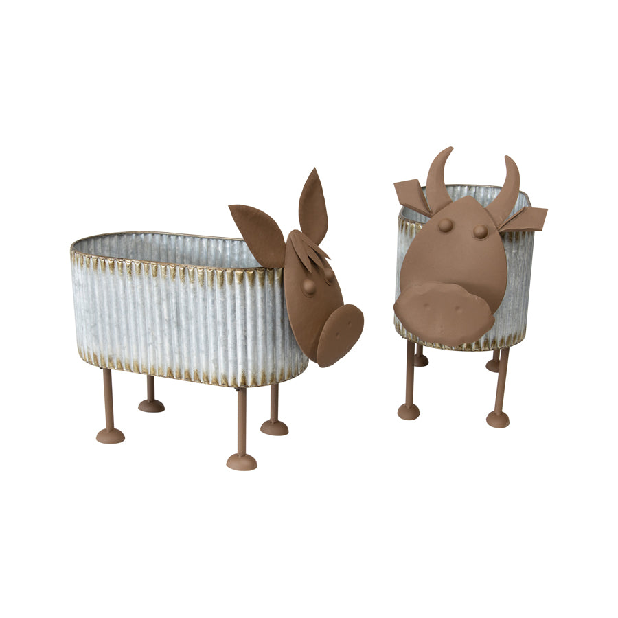 Nested Cow Planters Set of 2. Two animal-shaped planters with legs on a white background