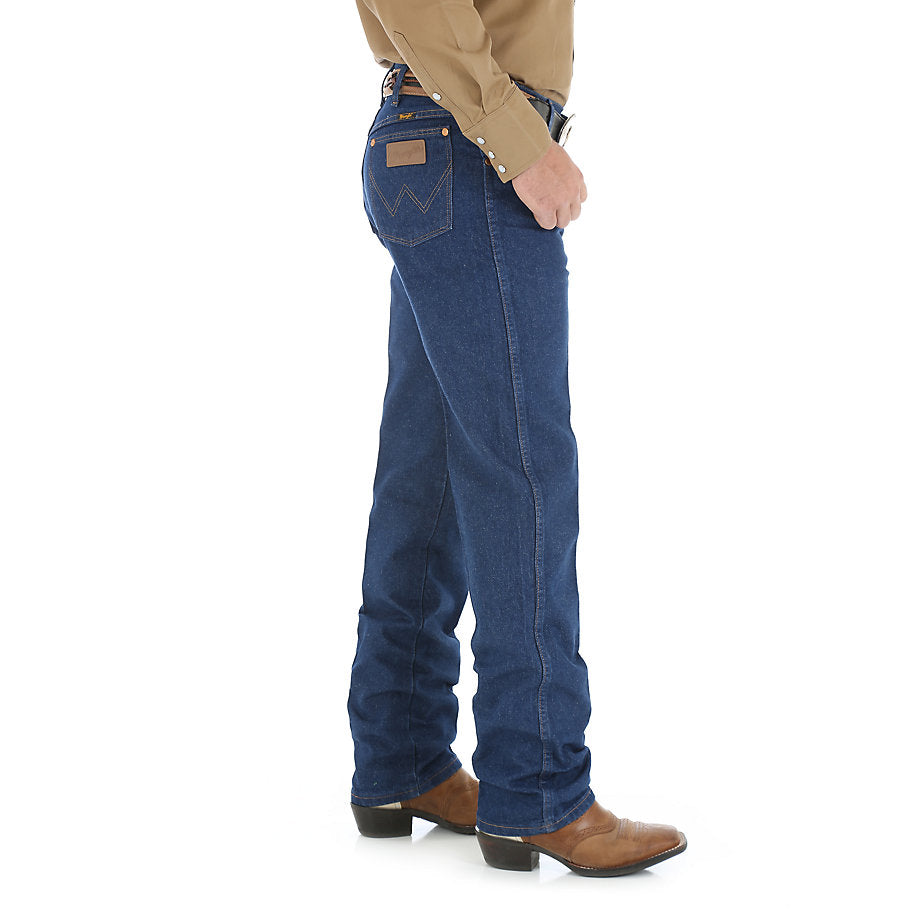 A man wearing Wrangler Men's Prewashed Original Fit Jean and a brown belt with a silver buckle, standing against a white background.