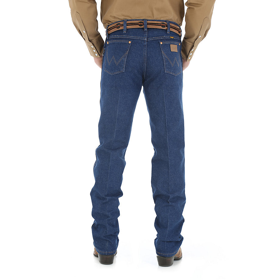 A man wearing Wrangler Men's Prewashed Original Fit Jean and a brown belt with a silver buckle, standing against a white background.