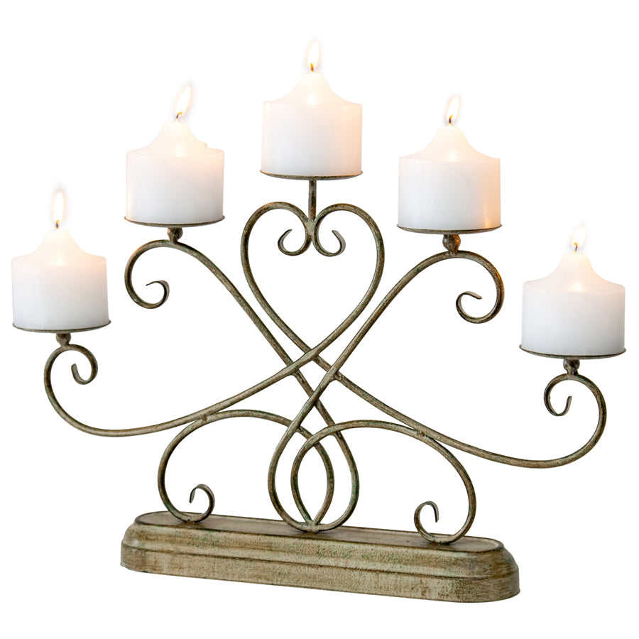 Ornate Fleur Candelabra Centerpiece. Decorative candle holder with five candles on a white background