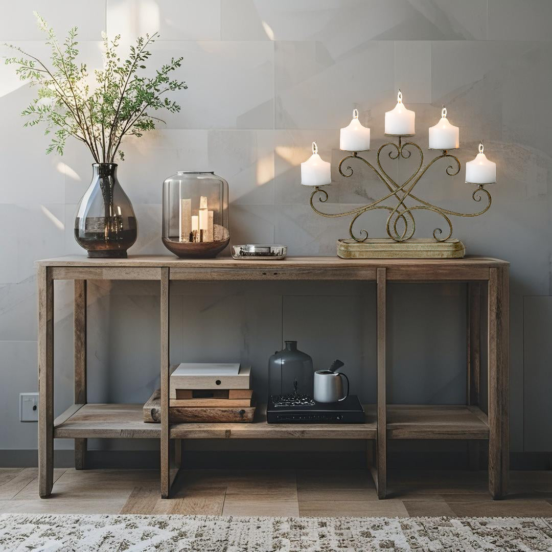 Ornate Fleur Candelabra Centerpiece. Wooden console table with decorative items against a gray wall