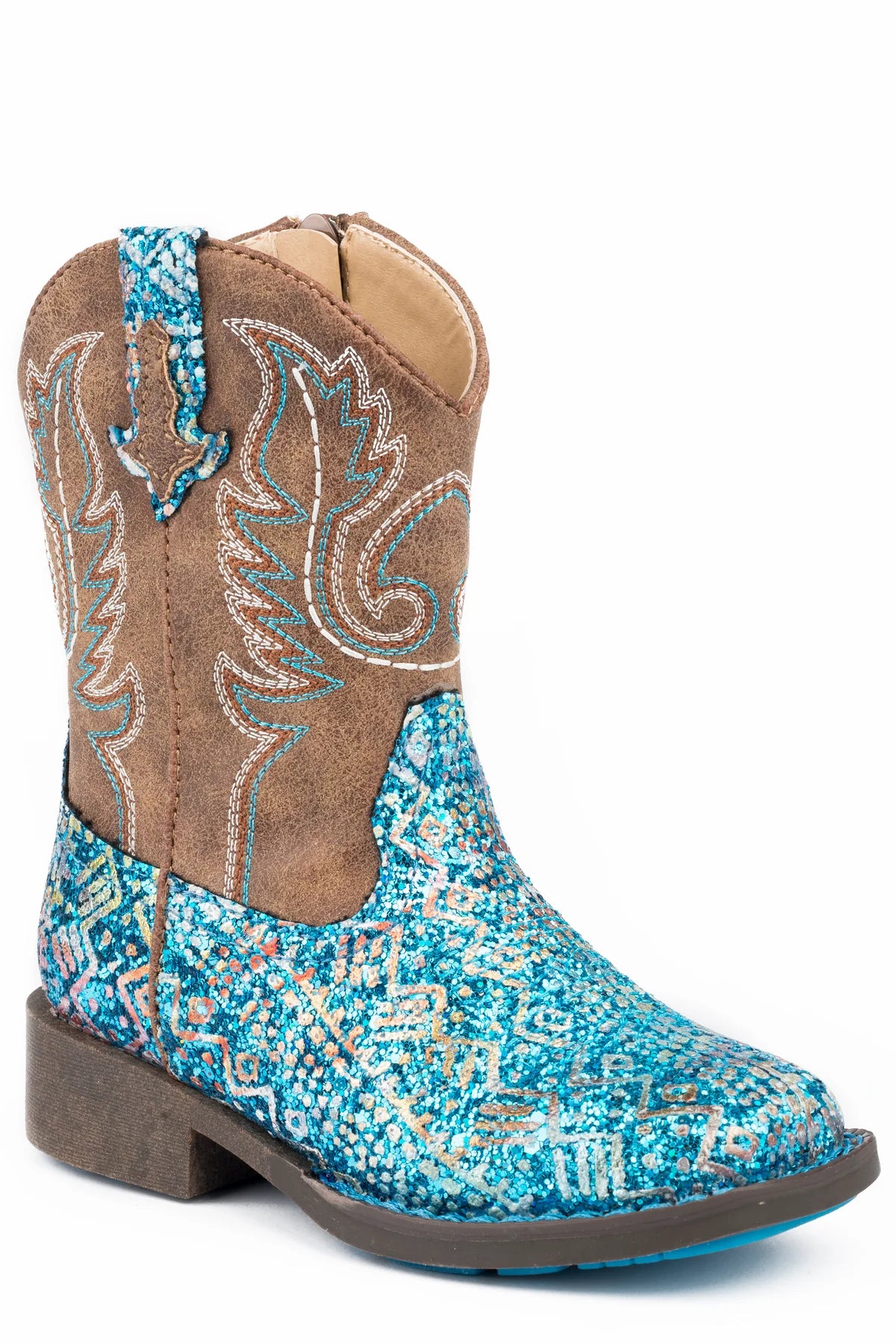 Roper Glitter Aztec Toddler Western Boot. Toddler's Western boot with blue glitter on the vamp and a brown shaft featuring a stitch design. The boot includes a side zipper for easy wear.