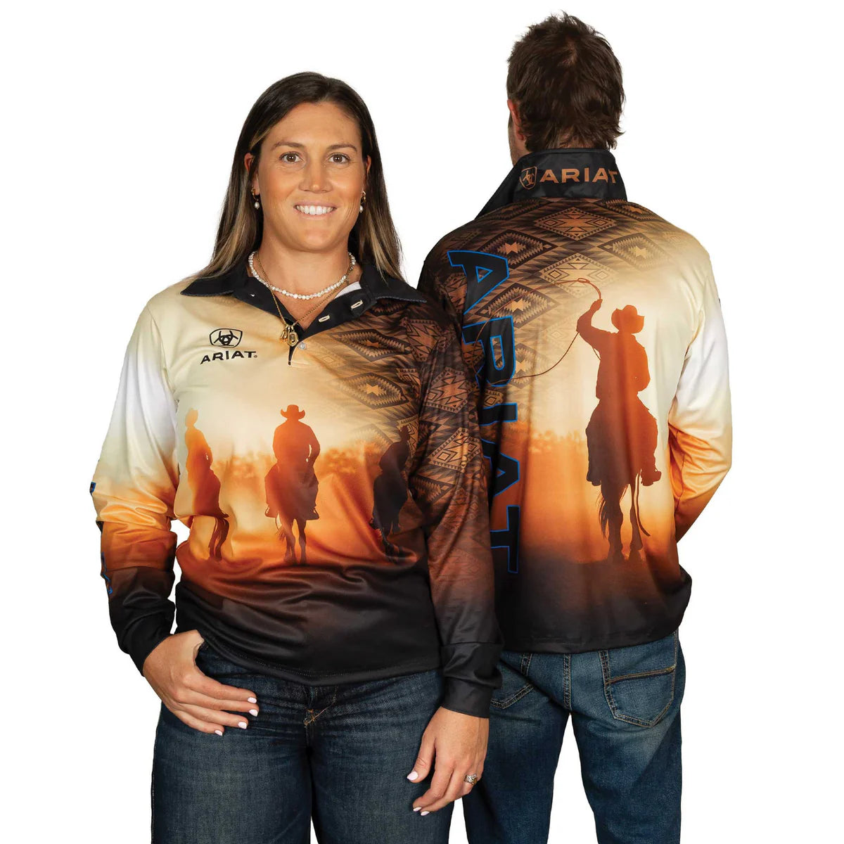 Ariat Unisex Rodeo Roper Fishing Shirt. Two people wearing a long-sleeve shirt with a sunset design and 'Ariat' branding.