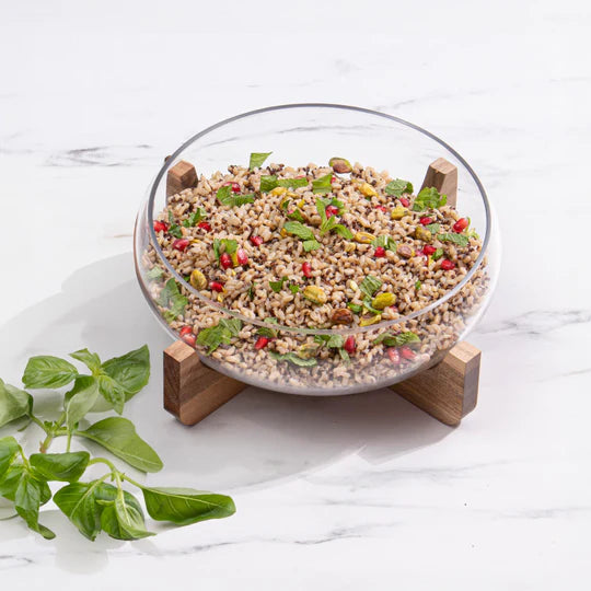 Gather Small Glass Salad Bowl. Clear glass bowl on a wooden stand against a white background