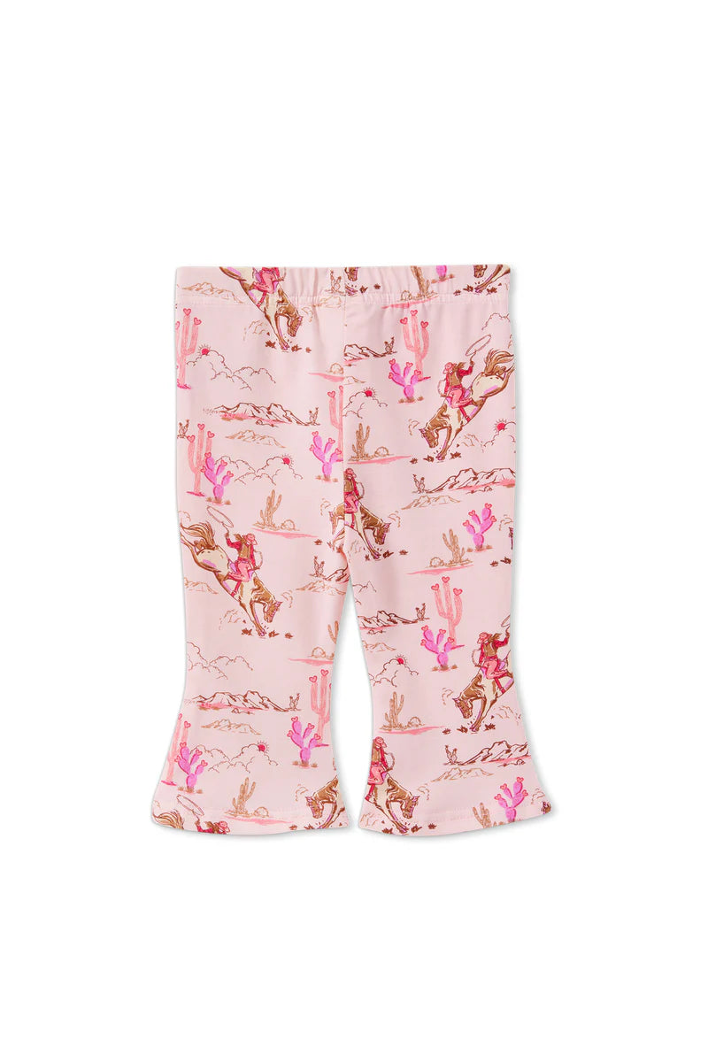 Flared pants with a cactus and horse pattern on a pink background