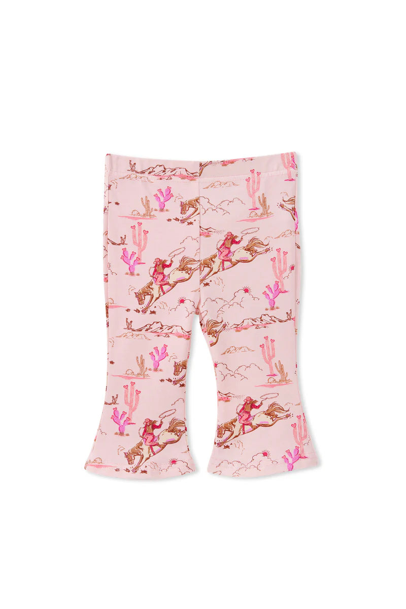 Flared pants with a cactus and horse pattern on a pink background