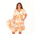 Women's Freedom Flame "Ellie" Dress. Woman wearing a patterned dress on a white background