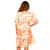 Women's Freedom Flame "Ellie" Dress. Woman wearing a patterned dress with a white background
