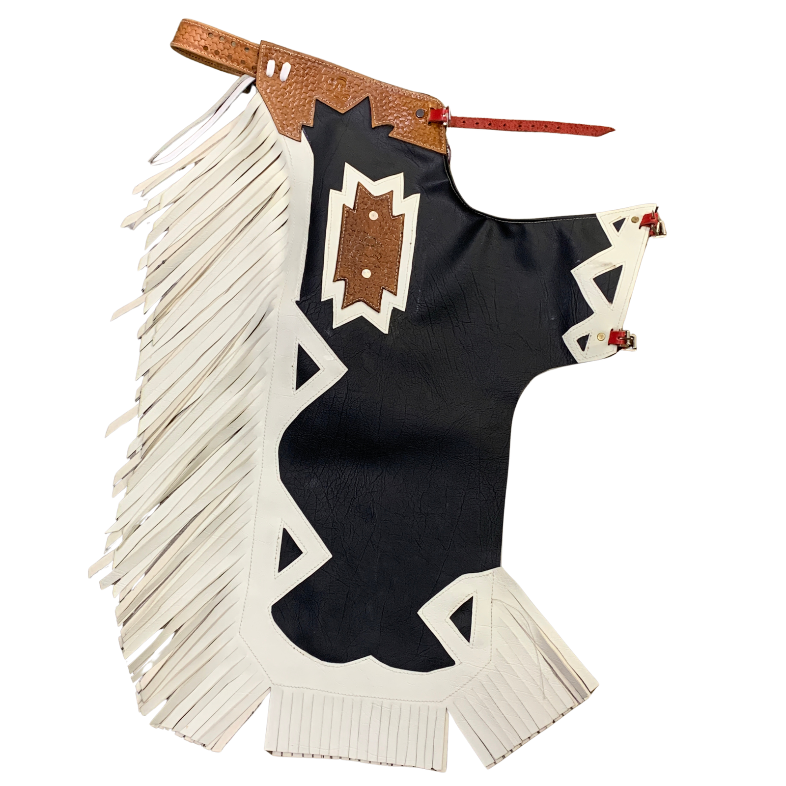 A black leather fringed chaps with white fringe trim, geometric white appliques, and a brown textured leather chest patch on a white background.