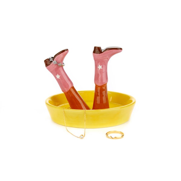 Happy Legs Ceramic Happy Legs. Pink cowboy boots with star decorations in a yellow holder on a white background