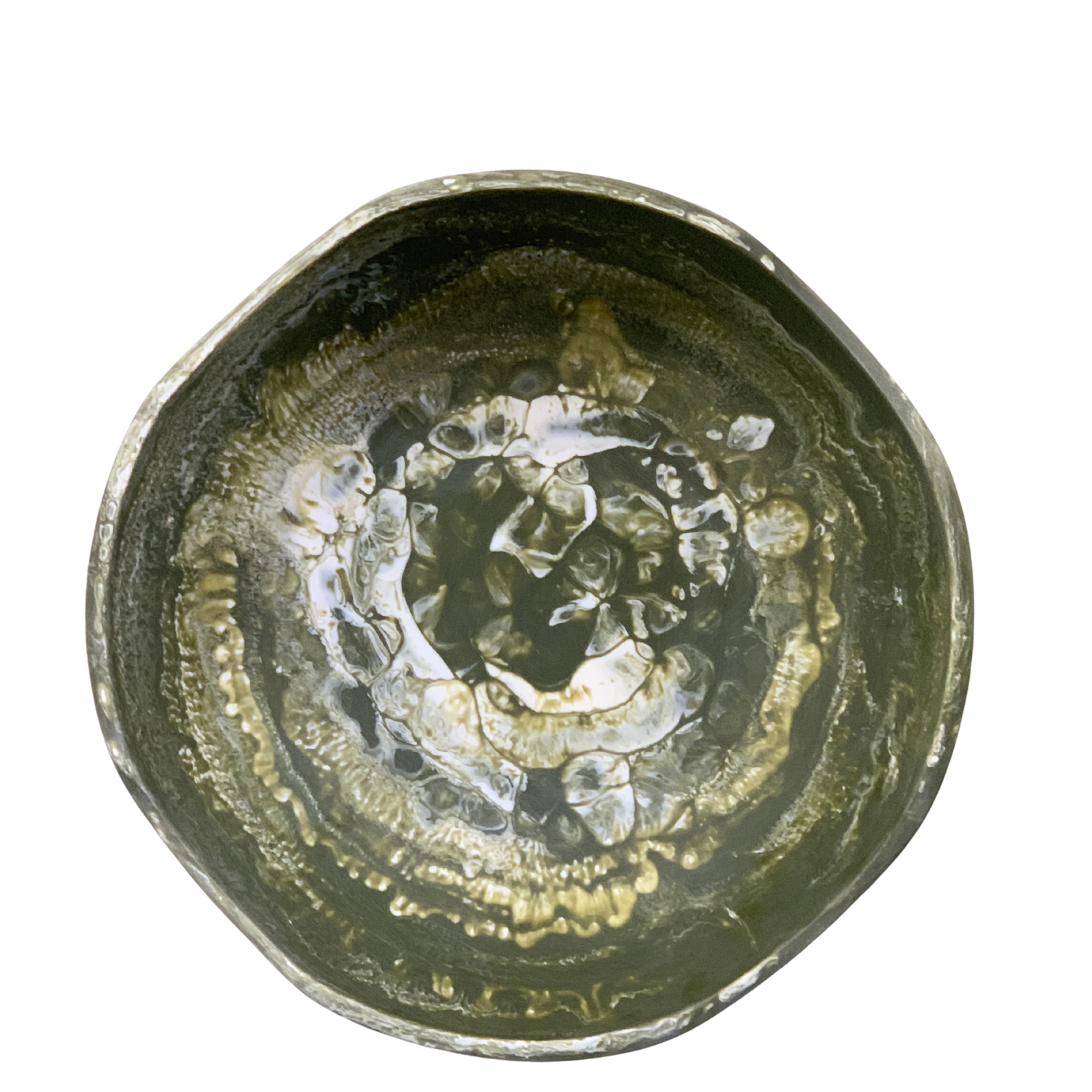 Round metallic object with intricate design on a white background