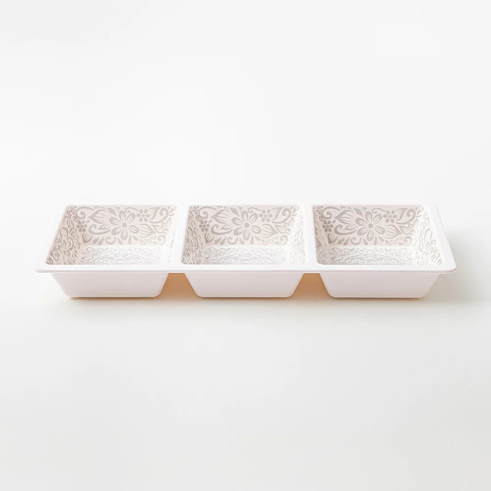Three small rectangular ceramic dishes with a raised floral pattern on the inside, arranged in a row on a clean white background.