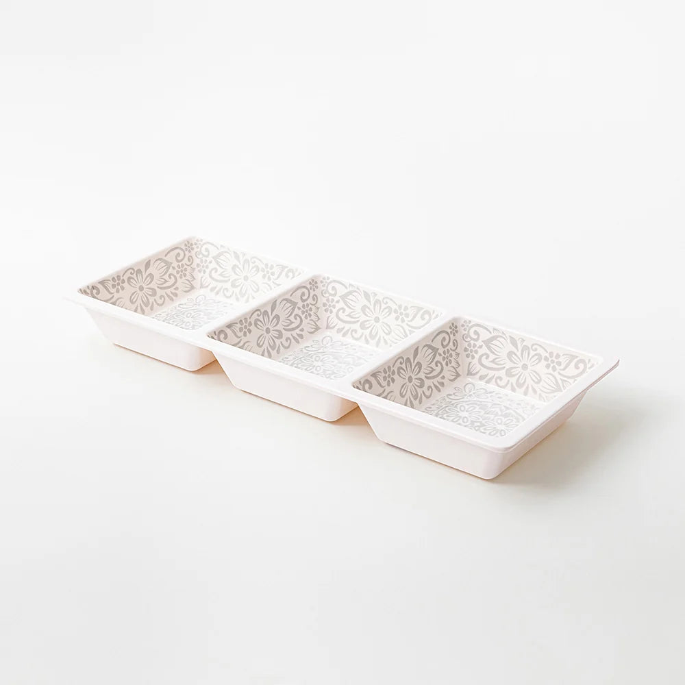 Three small rectangular ceramic dishes with a raised floral pattern on the inside, arranged in a row on a clean white background.