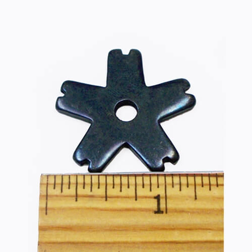 Barstow Regular Bull Riding Rowels. A black metal bull riding rowel placed on top of a wooden ruler for measurement.