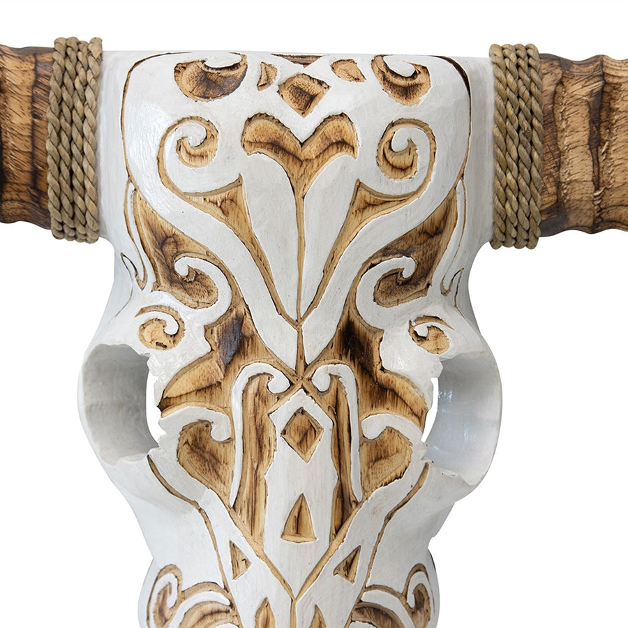 Hand Carved Animal Head Wallart. Decorative axe head with intricate patterns and wooden handle on a white background