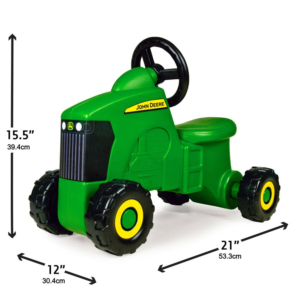 John Deere Foot to Floor - Tractor Ride-On. Green toy tractor with black wheels and yellow accents on a white background
