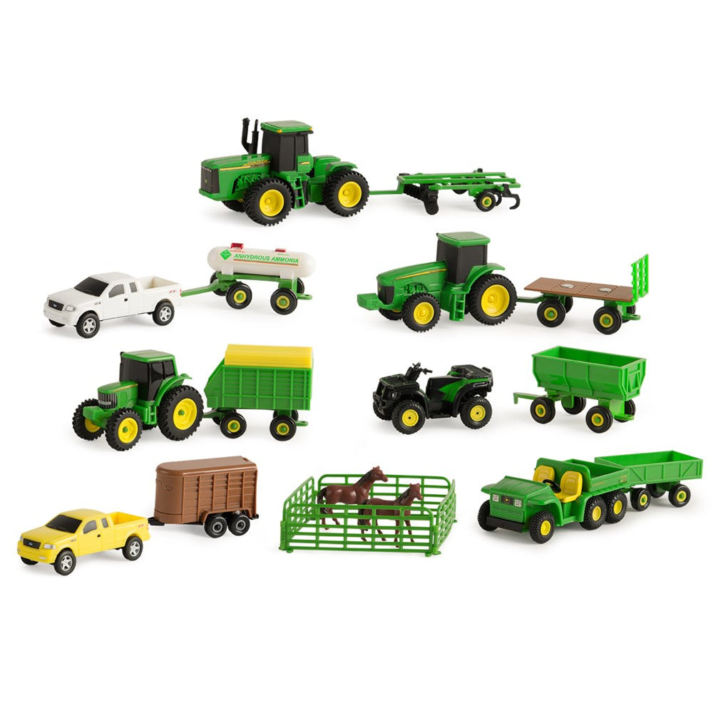Collection of toy farm vehicles including tractors and trailers on a white background