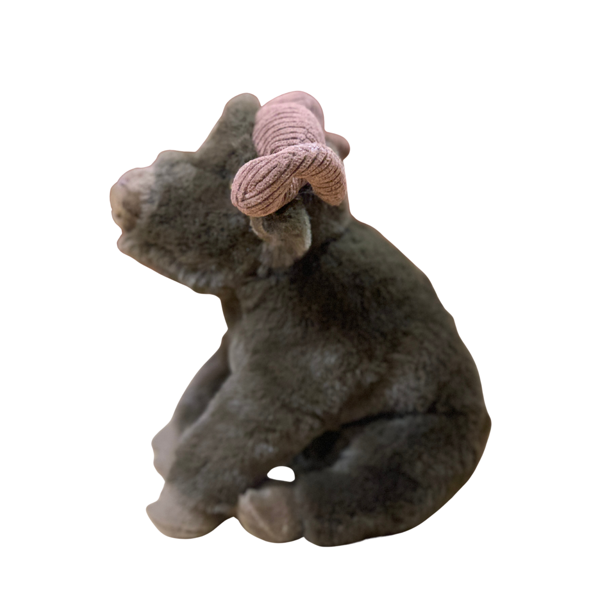 Plush bear with a pink knitted bow on a white background