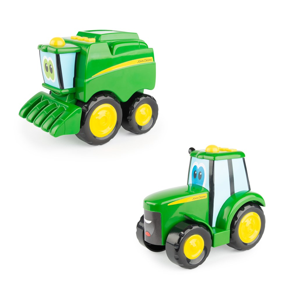 Toy tractor and combine harvester set on a white background