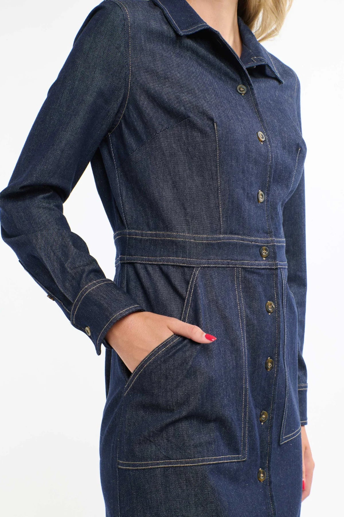 A close up view of a woman wearing a 365 Women's Sabrina Denim Dres. A blue denim dress on a white background