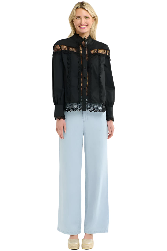 Woman wearing a 365 Women's Victoria Blouse. Black lace-trimmed  with light blue jeans on a white background