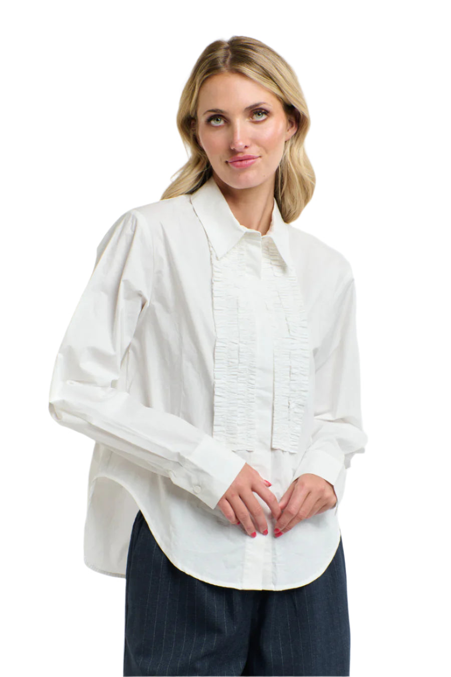 Woman wearing a 365 Women's Tuxedo Shirt. A light pink blouse with ruffled details on a white background