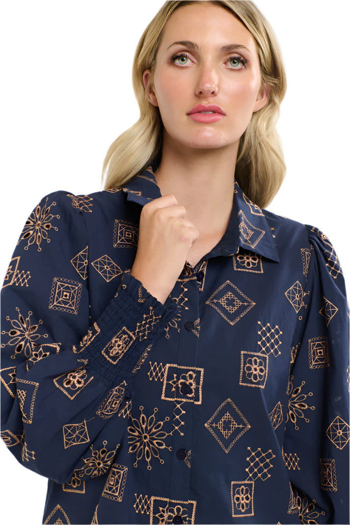 Woman wearing a 365 Women's Mandala Blouse dark blue patterned blouse with a plain background