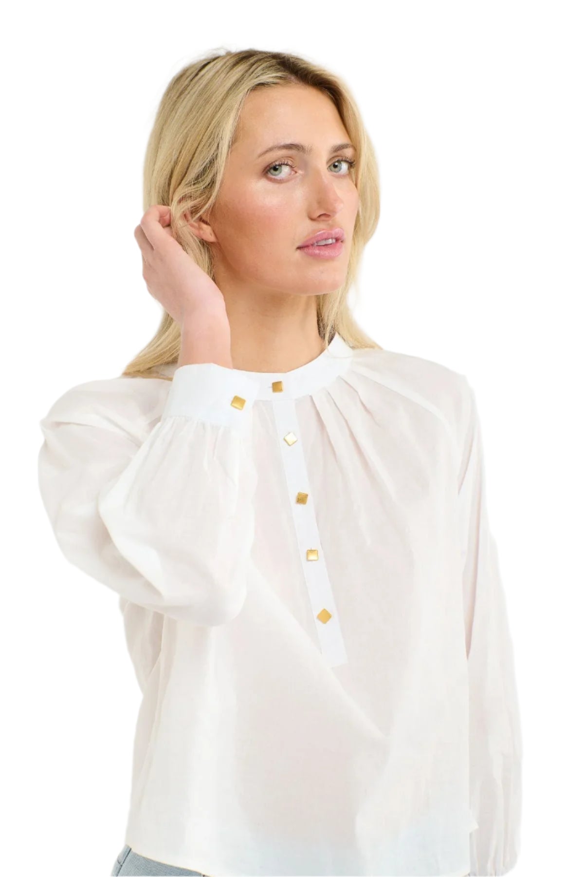 Close up of a woman wearing a 365 Women's Layla Cotton Top. A white blouse with gold buttons on a white background