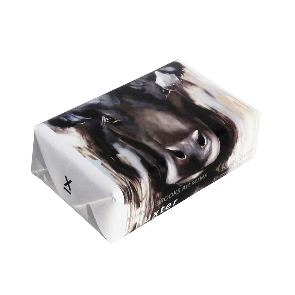 Huxter Angus Cow Soap. A packaged bar of Huxter Angus Cow Soap with a black and white cow pattern on the wrapping.