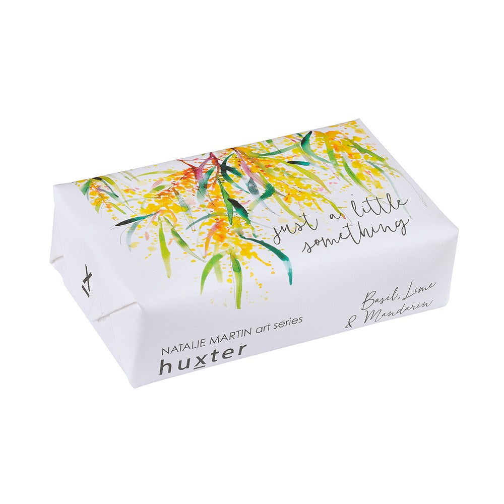 Huxter Just A Little Something Soap. A packaged bar of Huxter soap with a floral design and the text 'Just a little something' on top.